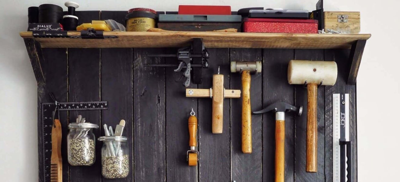 Tools hanging on a tool rack on the wall.