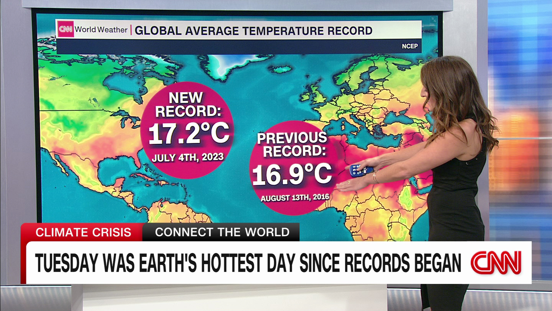 Screen cap of a weather person on the TV news in front of a map with the map’s caption pointing out that Tuesday was earth’s hottest day since reocrds began.